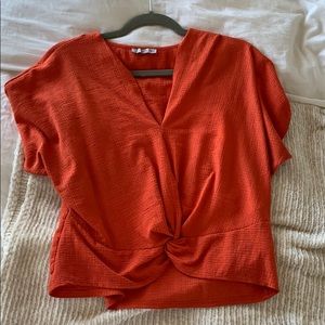 Orange top with a knot